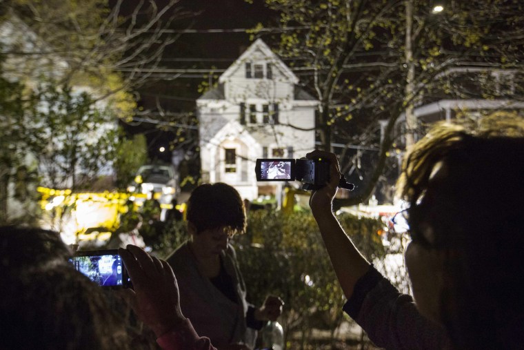 Image: Neighbors use cameras to record images of the boat at 67 Franklin St. where Dzhokhar Tsarnaev, suspect in Boston Marathon bombings, was hiding inside in Watertown
